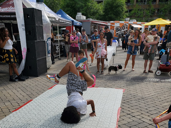 FunkyAzhido mid-performance — street dance freestyle with bostaff and martial arts influences