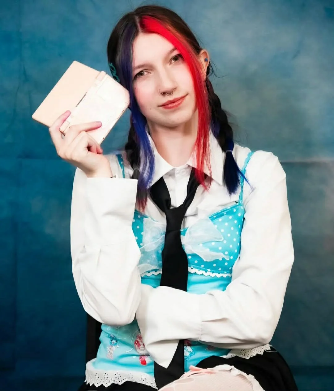 Kas Raines — split red and purple braids, anime-inspired outfit with polka dot top and black tie