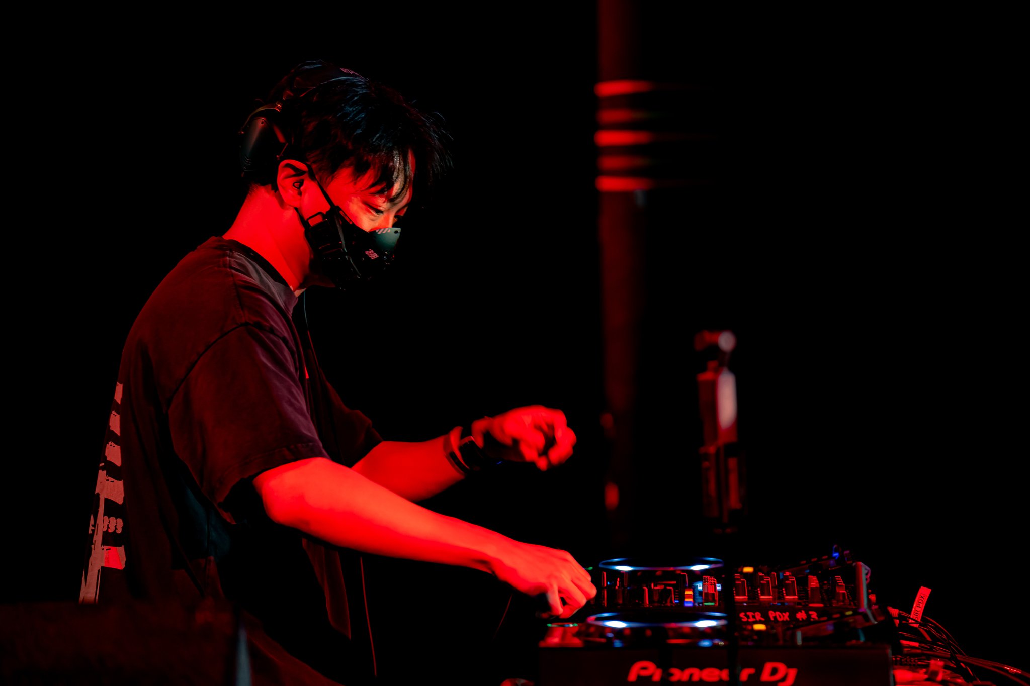 NINJ3FF3C7 โ anime EDM DJ performing live, red stage lighting on Pioneer DJ equipment