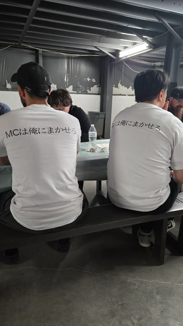 Performers and staff in KPC 2026 crew shirts at the pre-event welcome dinner